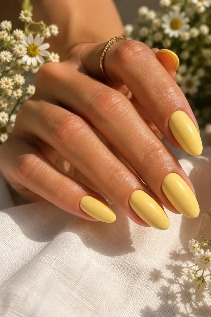 Butter yellow summer nails with glossy almond-shaped manicure