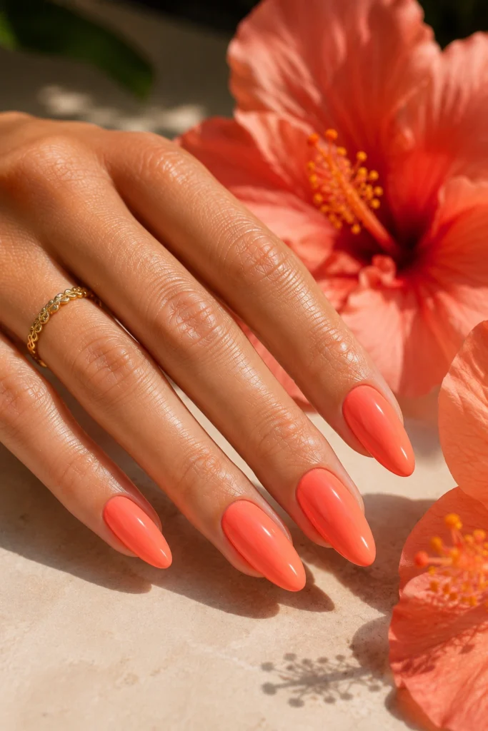 Glossy coral nail color for a classic summer manicure