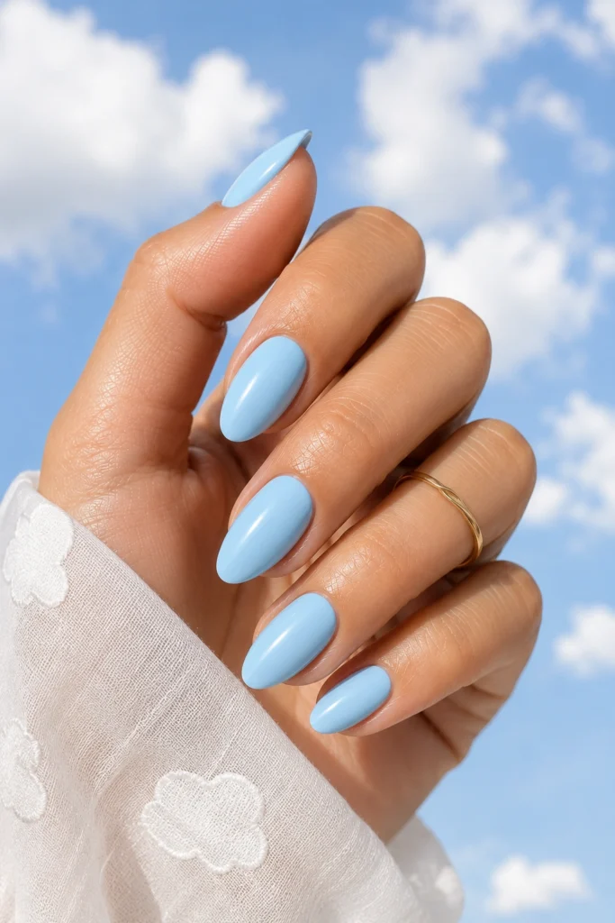 Soft sky blue summer nail color trend 2026 with glossy finish